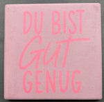 Bedruckte Fliese oder Untersetzer mit motivierendem Schriftzug „Du bist gut genug“ in kräftigem Pink auf violettem Hintergrund – modernes Statement-Design für Zuhause oder als Geschenk.